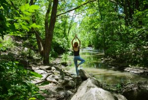 a woman practicing yoga and mindfulness as self care